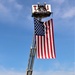 Firefighters and the American flag for Fort McCoy Garrison Change of Command ceremony