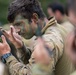 Australian Army Soldier applies camouflage paint