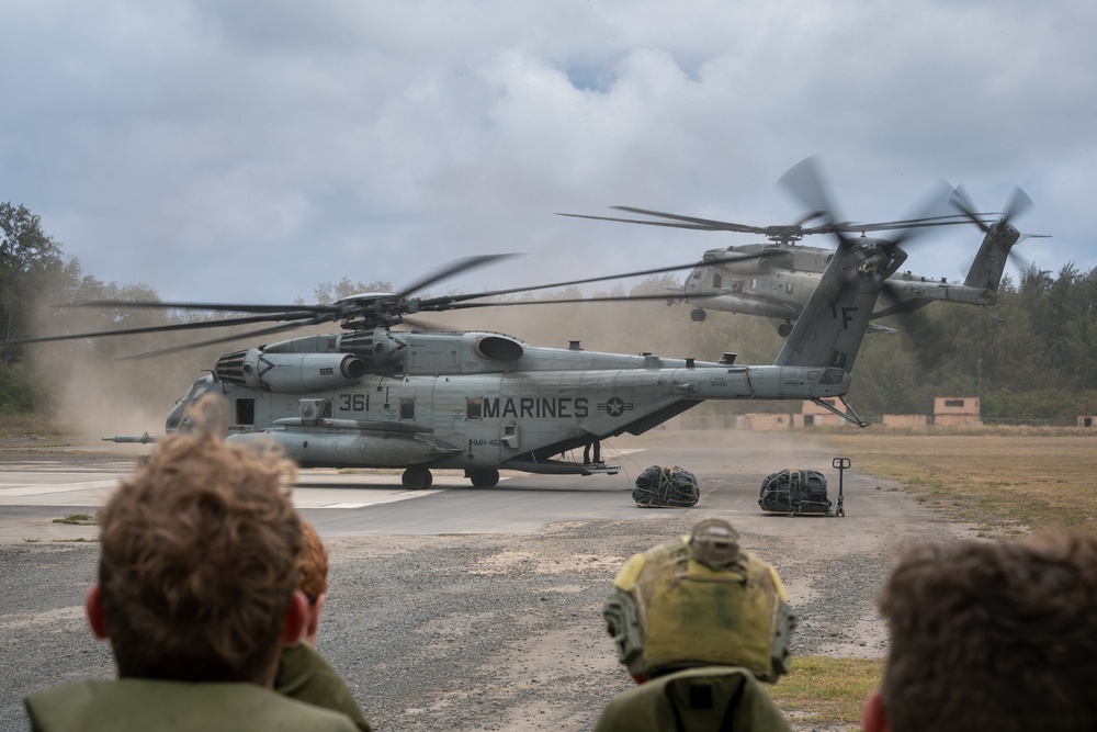 Two CH-53E Super Stallions take off