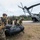 U.S. Marines carry a boat onto a CH-53E helicopter