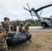 U.S. Marines carry a boat onto a CH-53E helicopter