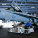 Abraham Lincoln Sailors transport aircraft in the hangar bay