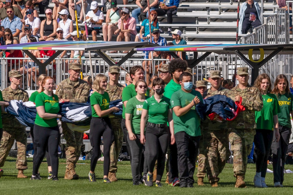 Oregon Army National Guard Soldiers, U of O Marching Band, ROTC cadets carry US Flag during World Track and Field Championships