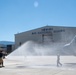 Post Flight Shower: Senior Master Sgt. Kathy Backlund, a loadmaster for the 192nd Airlift Squadron, is sprayed after her final flight &quot;fini-flight&quot; in the C-130 Hercules