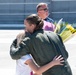 Senior Master Sgt. Kathy Backlund hugs her children after her final flight &quot;fini-flight&quot; in the C-130