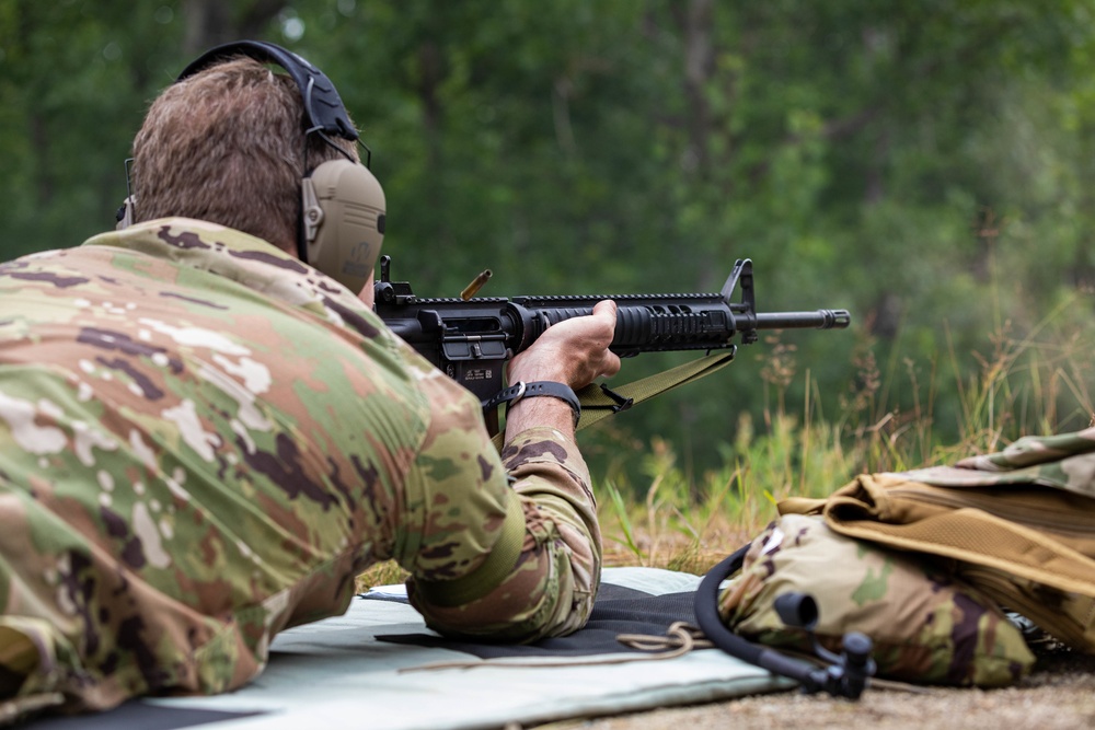 Col. Brent Dishman fires a M16 rifle