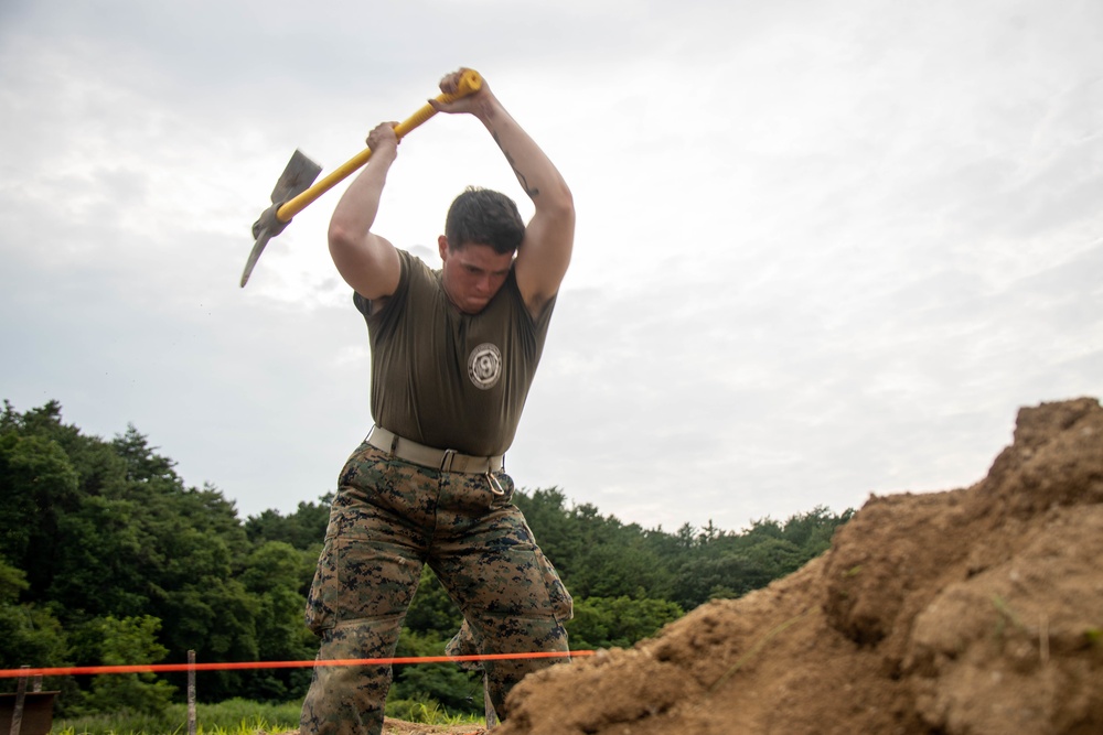 Marines with 9th Engineer Support Battalion construct a non-standard bridge with support from U.S. Navy Seabees