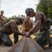 Marines with 9th Engineer Support Battalion construct a non-standard bridge with support from U.S. Navy Seabees