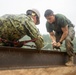 Marines with 9th Engineer Support Battalion construct a non-standard bridge with support from U.S. Navy Seabees