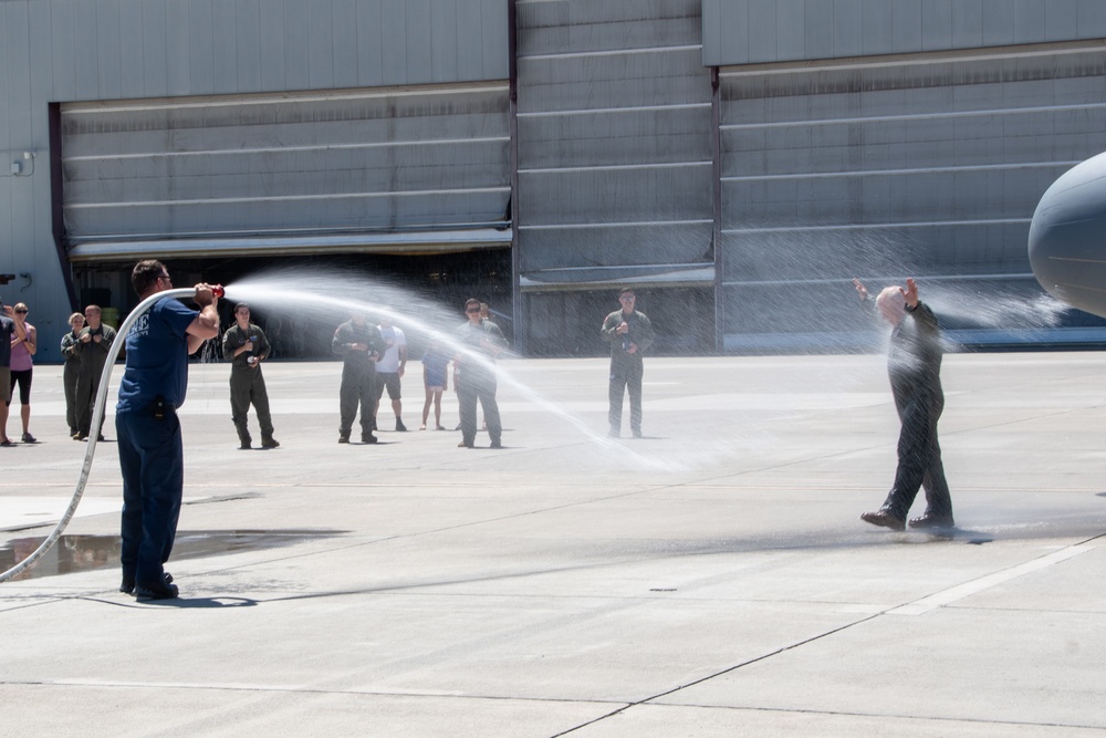Fini-Flight Shower: Lt. Col. Charles Steffens, II is sprayed after completing his final flight &quot;Fini-Flight&quot; in the C-130 Hercules