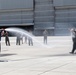 Fini-Flight Shower: Lt. Col. Charles Steffens, II is sprayed after completing his final flight &quot;Fini-Flight&quot; in the C-130 Hercules