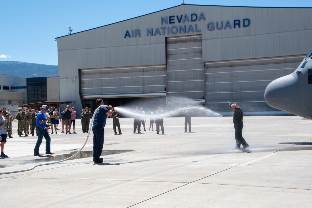 Fini-Flight Shower: Lt. Col. Charles Steffens, II is sprayed after completing his final flight &quot;Fini-Flight&quot; in the C-130 Hercules