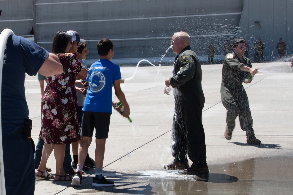 Champagne Shower: Lt. Col. Charles Steffens, II is doused with champagne by his family after completing his final flight &quot;Fini-Flight&quot; in the C-130 Hercules
