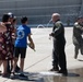Champagne Shower: Lt. Col. Charles Steffens, II is doused with champagne by his family after completing his final flight &quot;Fini-Flight&quot; in the C-130 Hercules