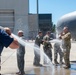 Fini-Flight Shower: Chief Master Sgt. Todd Houchens is sprayed after completing his final flight &quot;Fini-Flight&quot; in the C-130 Hercules