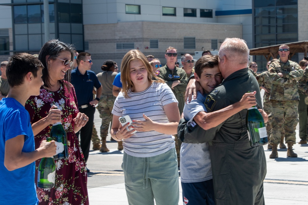 Lt. Col. Charles Steffens, II hugs his son after completing his final flight &quot;Fini-Flight&quot; in the C-130 Hercules