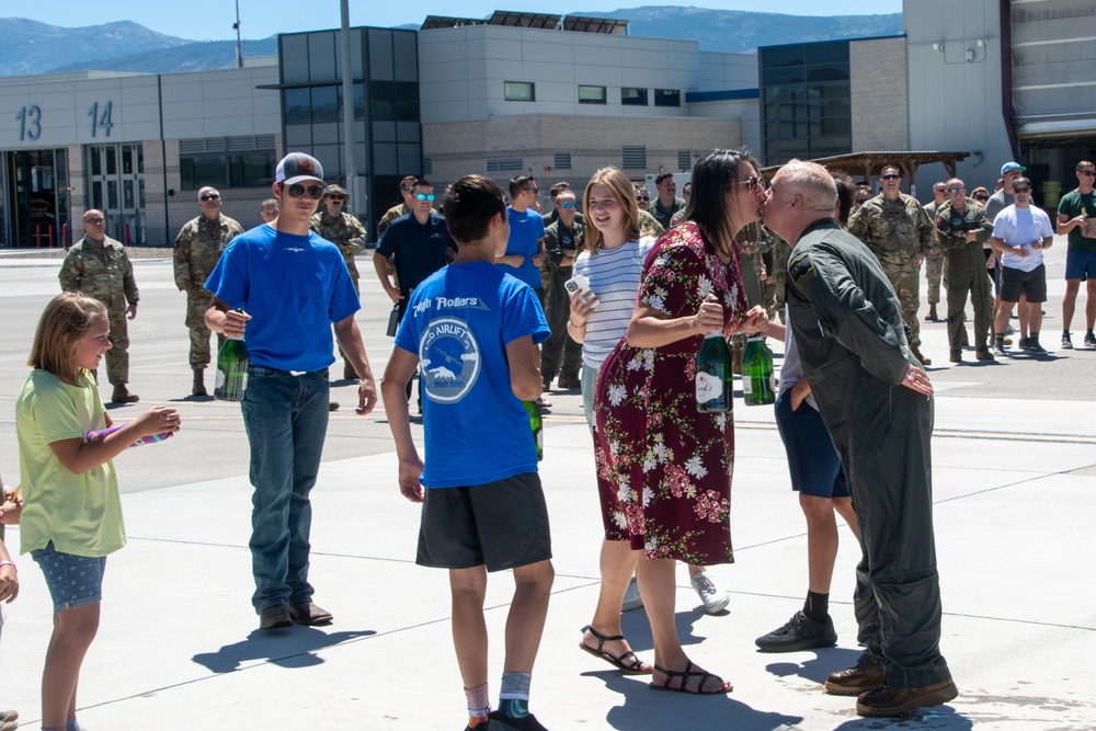 Lt. Col. Charles Steffens, II kisses his wife after completing his final flight &quot;Fini-Flight&quot; in the C-130 Hercules