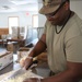 Culinary specialists prepares turkey dinner