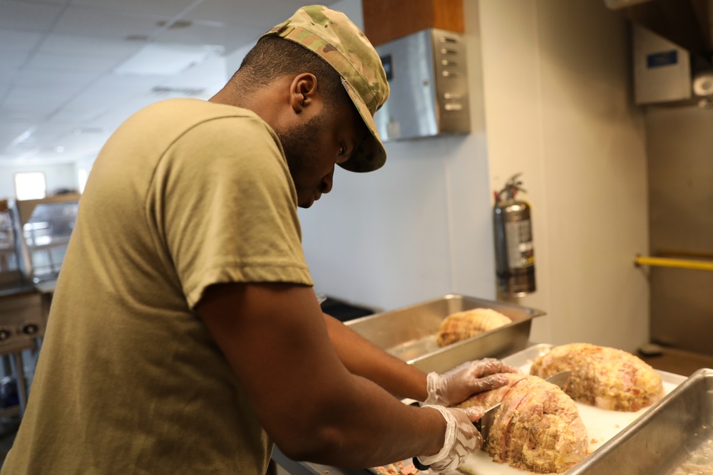 Culinary specialists prepares turkey dinner