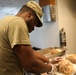 Culinary specialists prepares turkey dinner