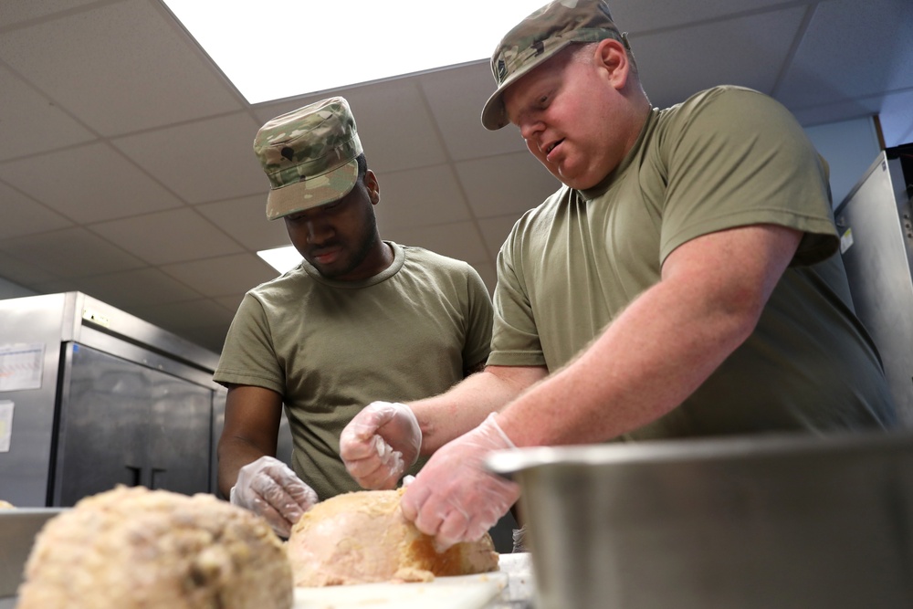 Culinary specialists prepares turkey dinner