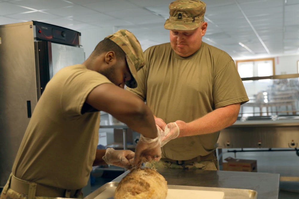 Culinary specialists prepares turkey dinner