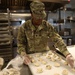 Culinary specialists prepares turkey dinner