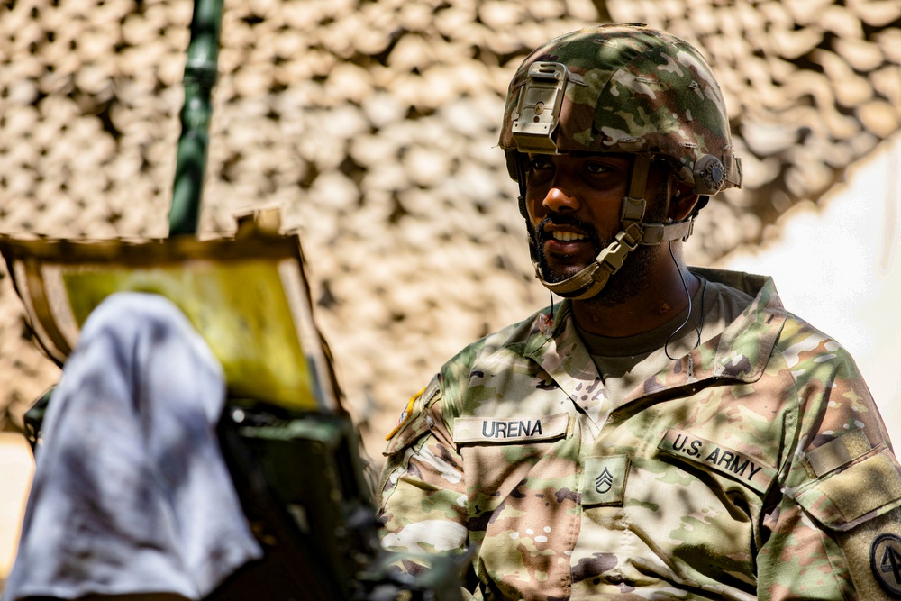 Soldiers of the 112th Field Artillery Regiment shoot 105mm Howitzers at XCTC