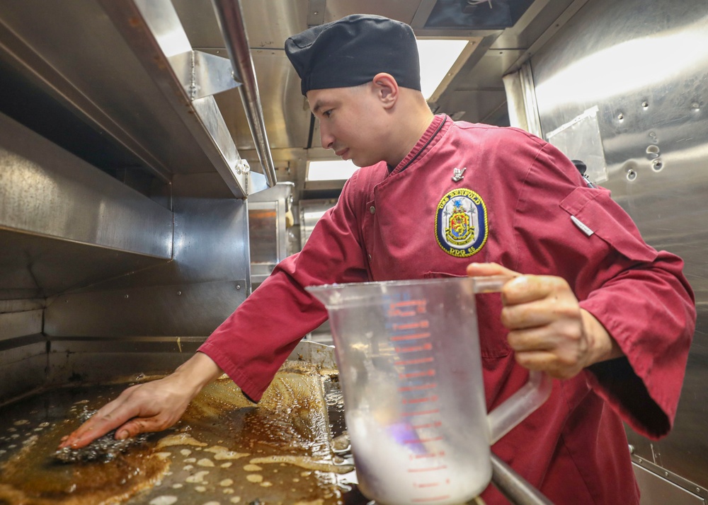 Culinary Specialist Cleans Grill