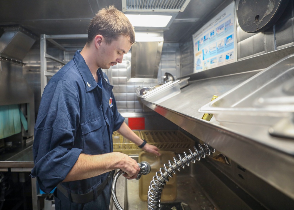 Food Service Assistant Cleans Tray