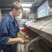 Food Service Assistant Cleans Tray