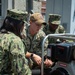 DC1 Murray teaches Sailors how to use P-100 pump