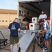 AFCT and support team members load equipment