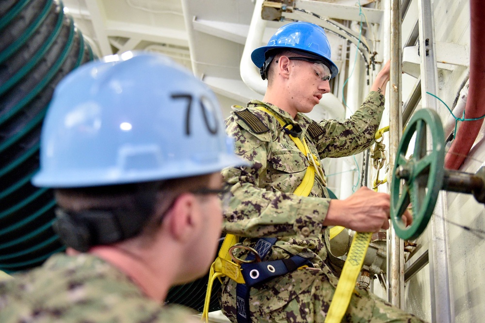 Sailors learn fall protection safety in the hangar bay of Nimitz-class aircraft carrier USS Carl Vinson