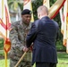 Craig L. Deatrick, accepts the unit colors from Command Sgt. Maj. Jason R. Copeland