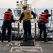 Sailors prepare the Hershel “Woody” Williams to get underway