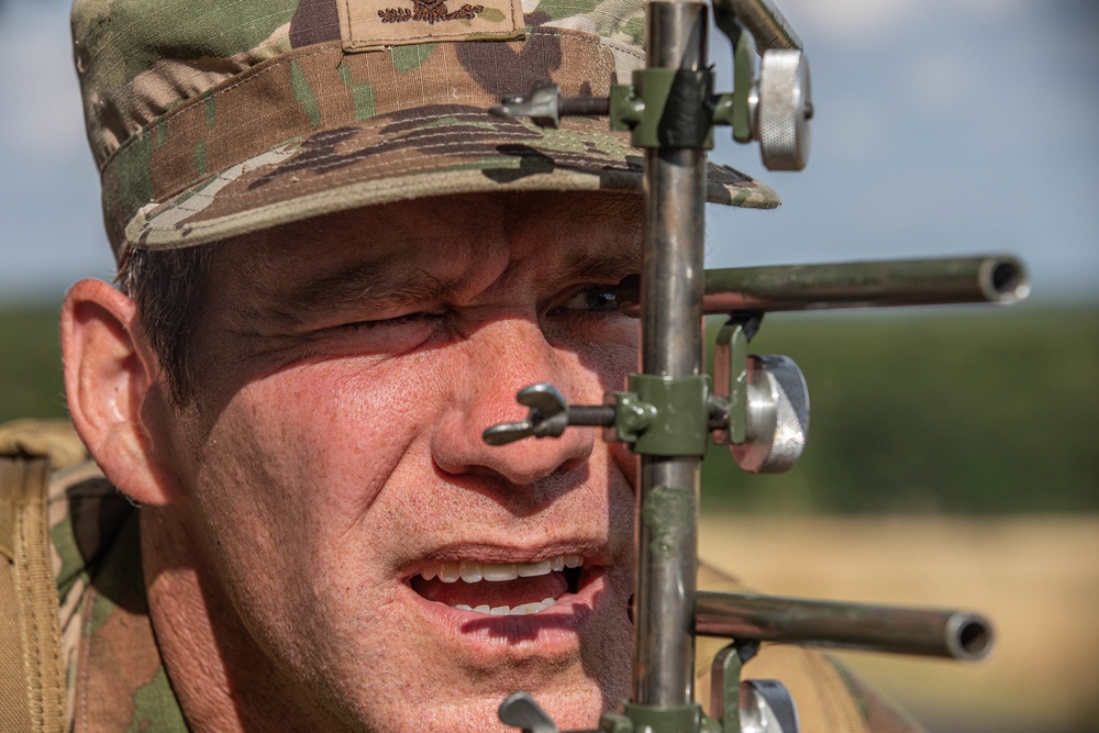 Col. Brent Dishman looks for an object