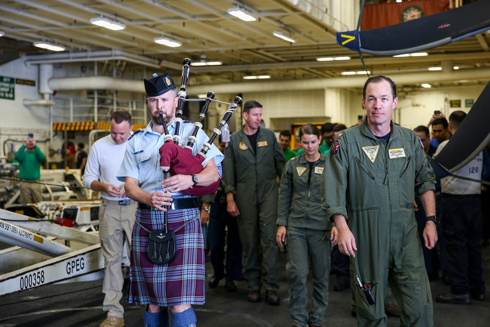 Royal Canadian Air Force Captain plays bagpipes aboard Abraham Lincoln during RIMPAC 2022