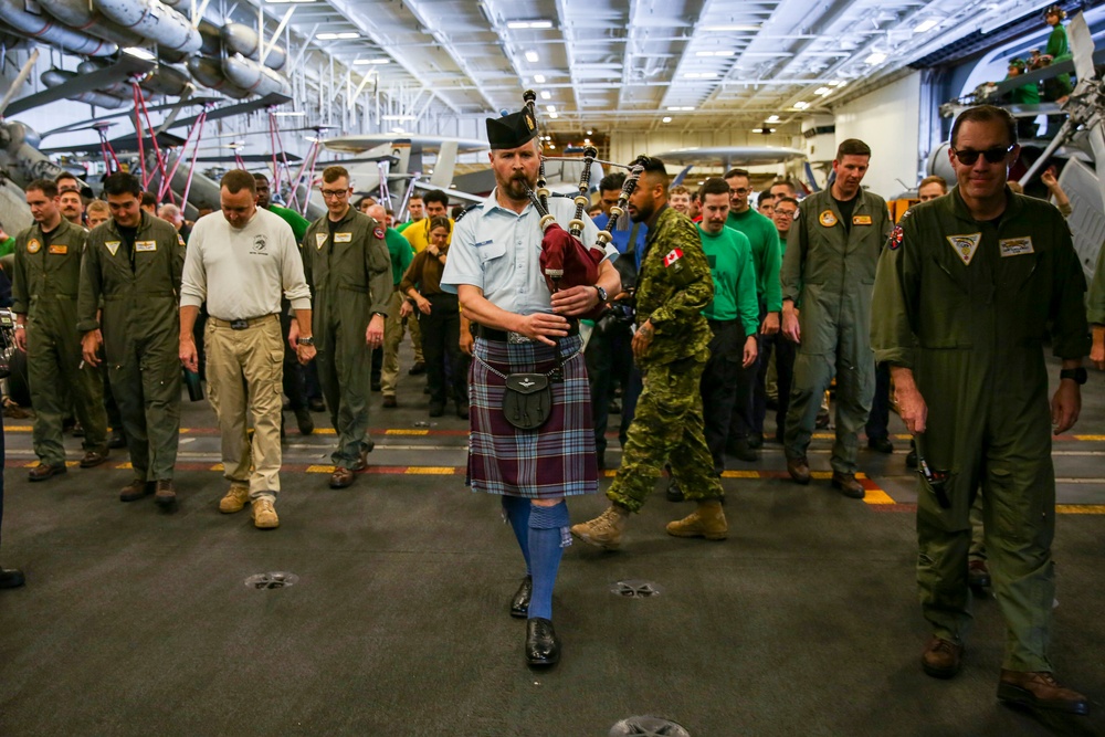 Royal Canadian Air Force Captain plays bagpipes aboard Abraham Lincoln during RIMPAC 2022