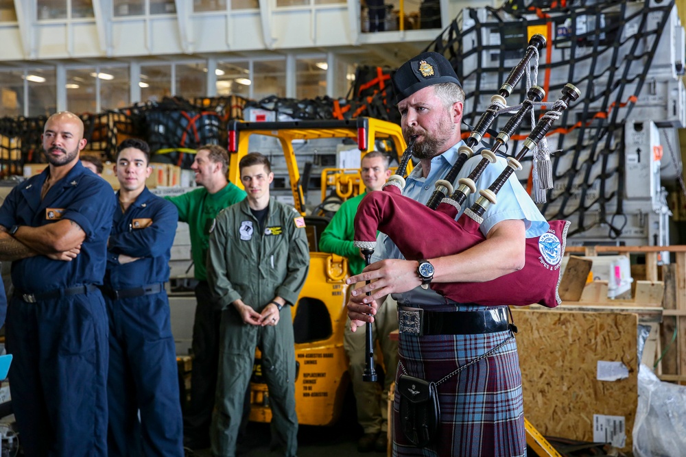 Royal Canadian Air Force Captain plays bagpipes aboard Abraham Lincoln during RIMPAC 2022