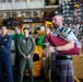 Royal Canadian Air Force Captain plays bagpipes aboard Abraham Lincoln during RIMPAC 2022