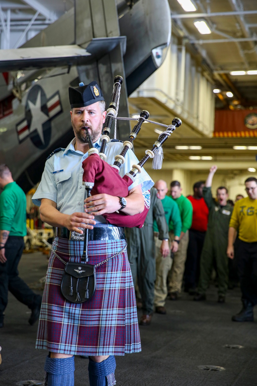 Royal Canadian Air Force Captain plays bagpipes aboard Abraham Lincoln during RIMPAC 2022