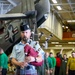 Royal Canadian Air Force Captain plays bagpipes aboard Abraham Lincoln during RIMPAC 2022
