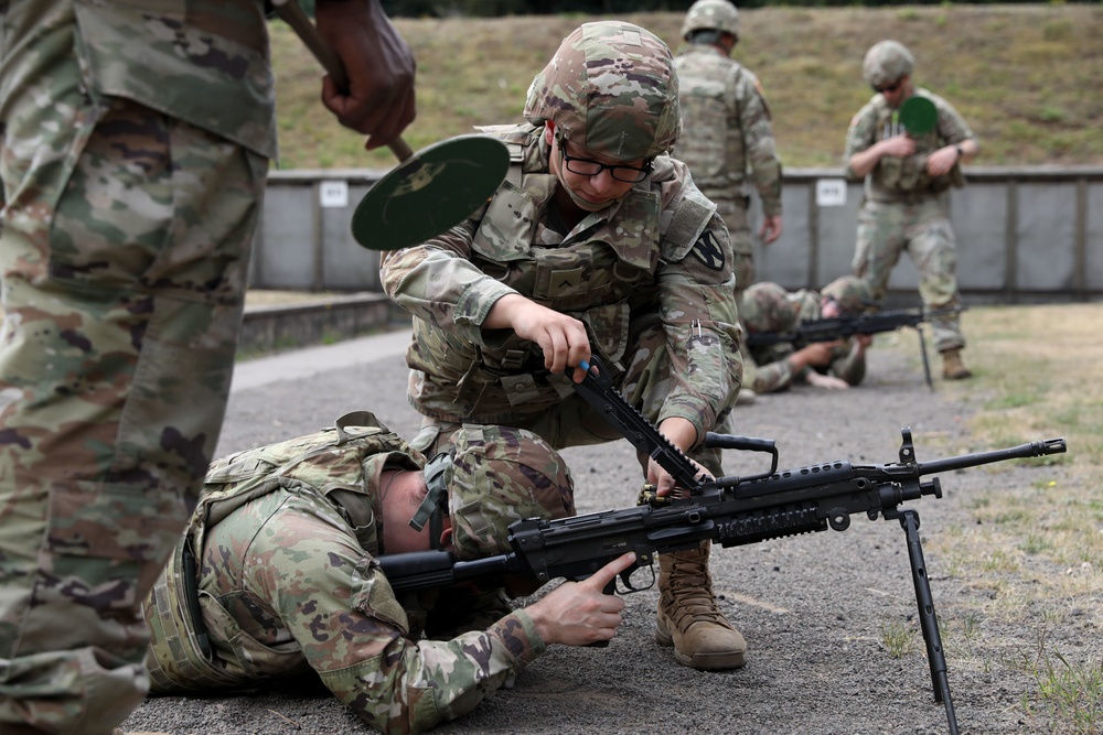 Soldiers from the 21st Theater Sustainment Command clear an M249 on range
