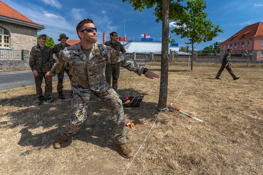 Maj. Sterling Broadhead throws a practice grenade