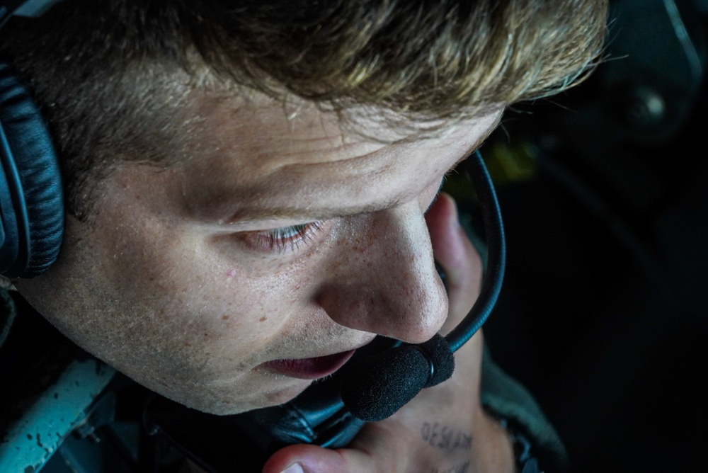 KC-135 boom operator looks through boom pod