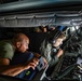 Boom operator and crew chiefs look out boom pod during aerial refueling