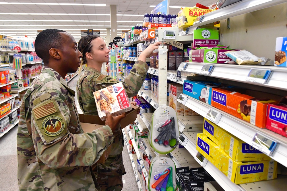 Airmen volunteers restock Commissary shelves