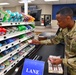 Airmen volunteers restock Commissary shelves