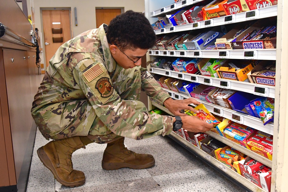 Airmen volunteers restock Commissary shelves